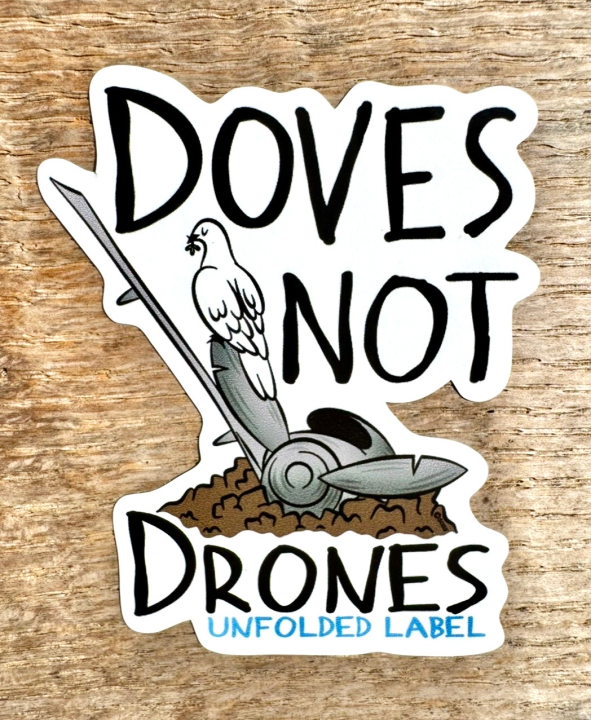 Protest sticker with 'Doves Not Drones' text and dove illustration on a wooden background by Unfolded Label