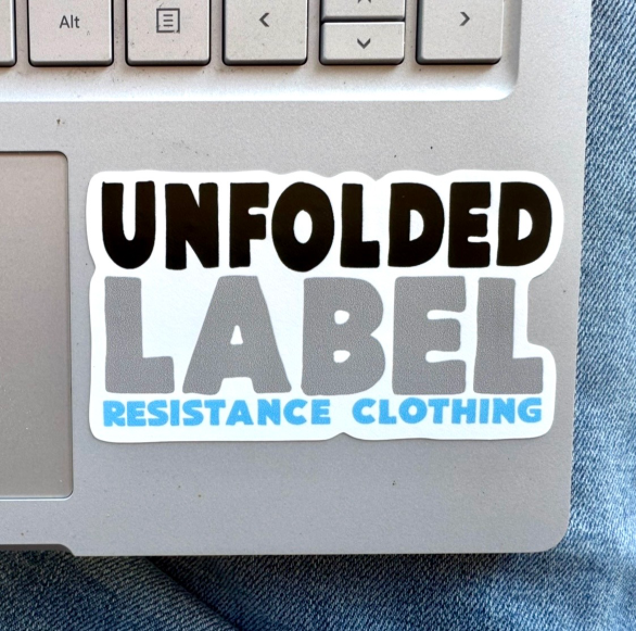 Sticker on a laptop with 'Unfolded Label Resistance Clothing' text. Protest brand.